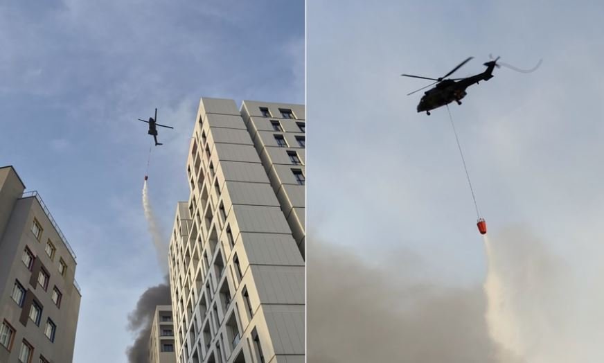 Helikopteri i zjarreve fluturon mbi pallate, lëshon ujë nga ajri për të ndihmuar zjarrfikësit! 